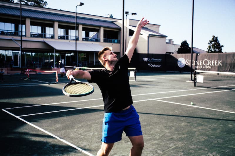 Gym member playing tennis