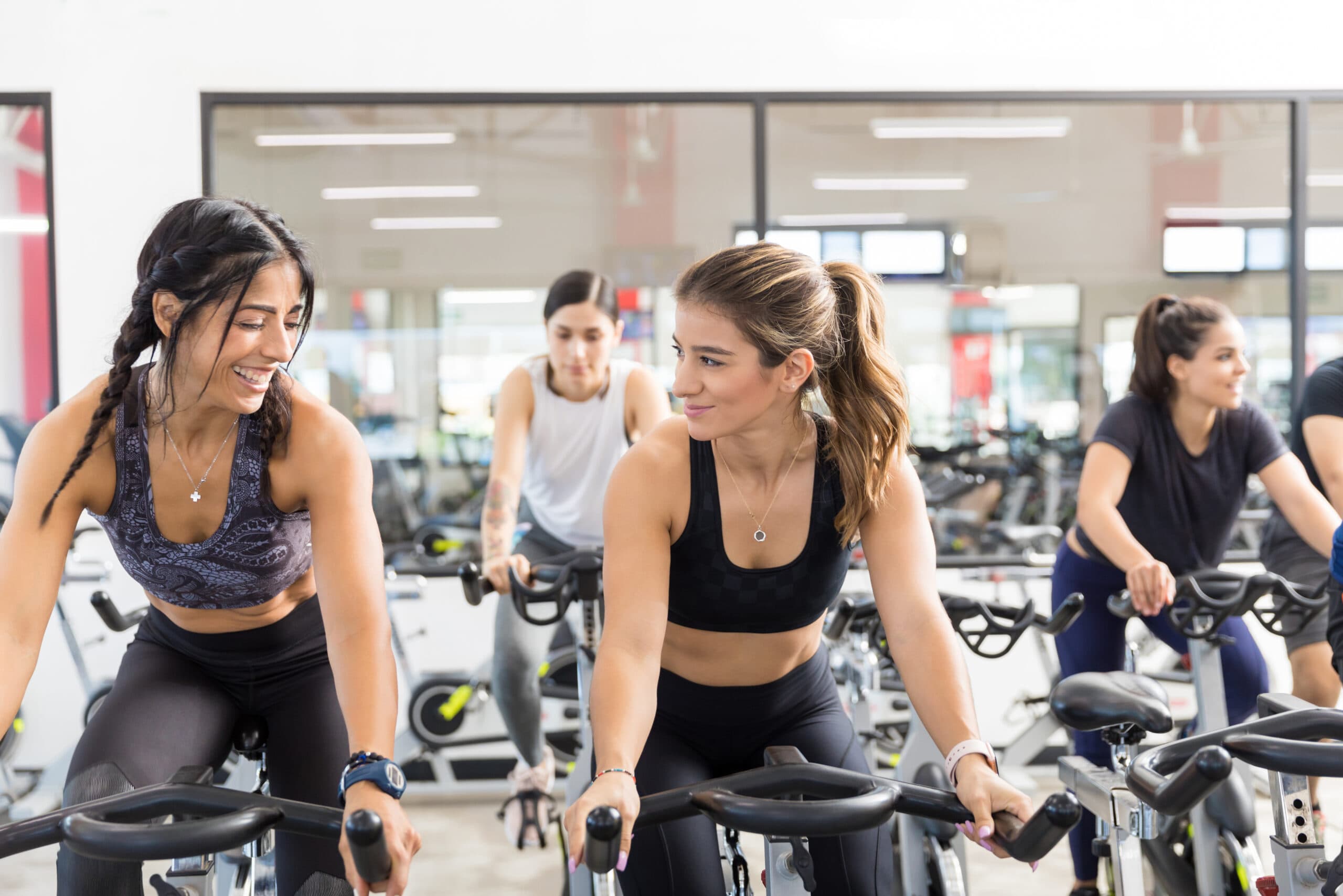 a group of people working out on the bicycle machine