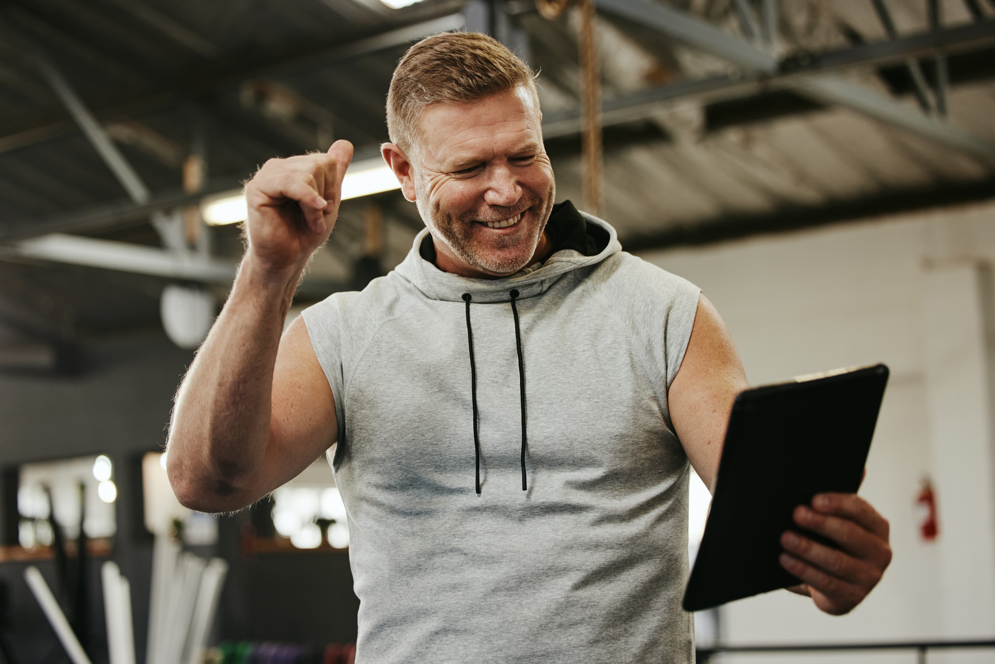 A person happy to see their tablet’s information