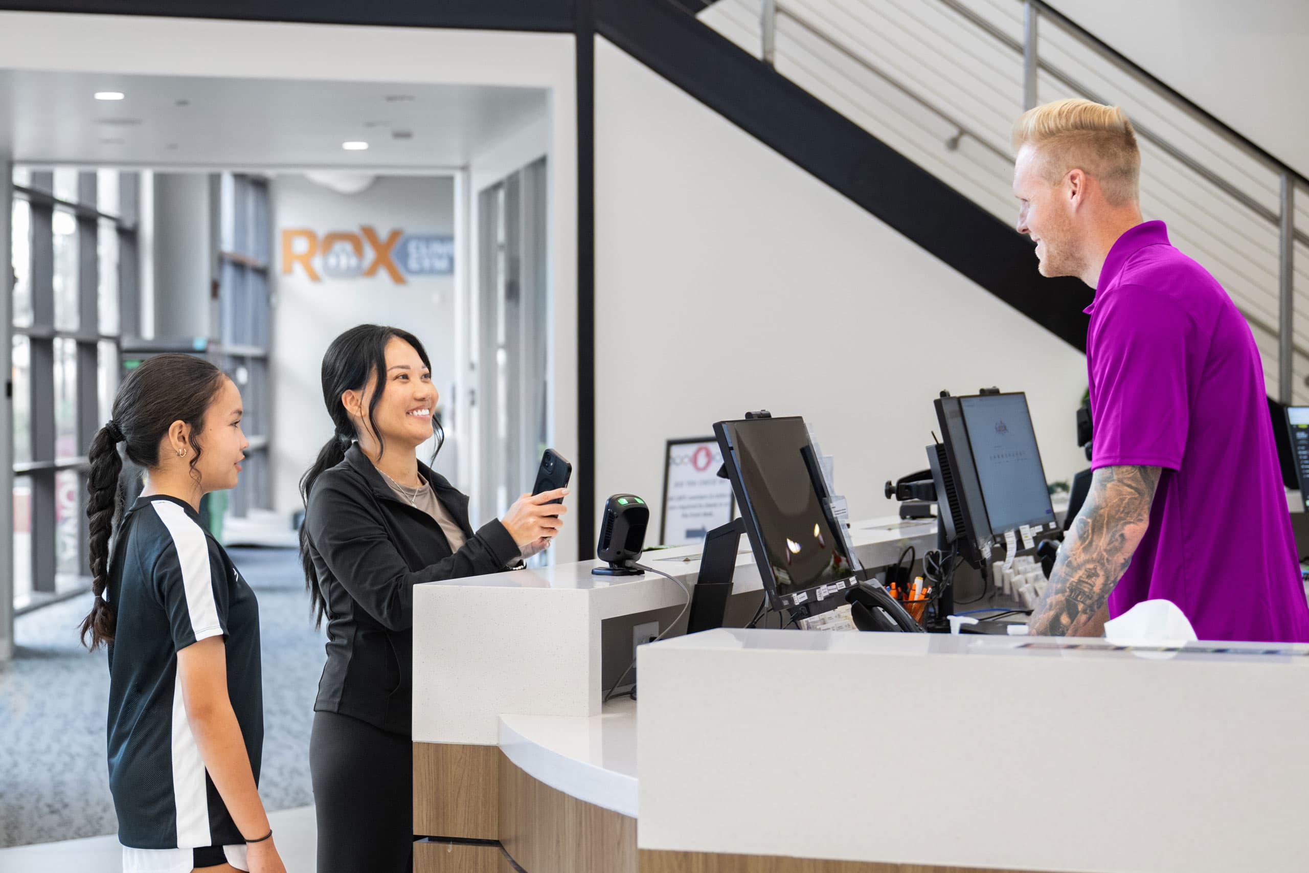 A gym member checking into a class using a fitness club mobile app