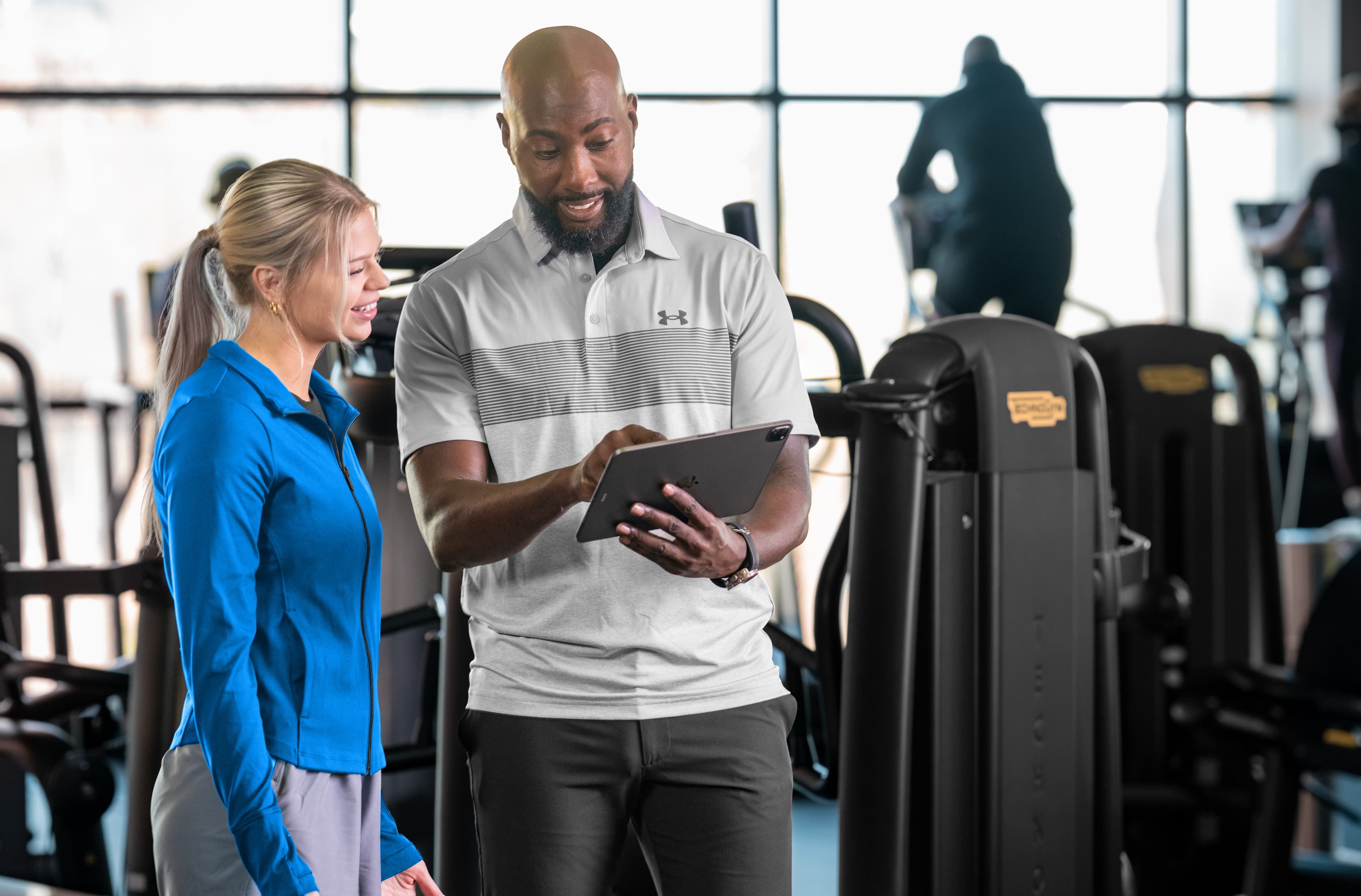 A trainer leading a group of members in a sports club