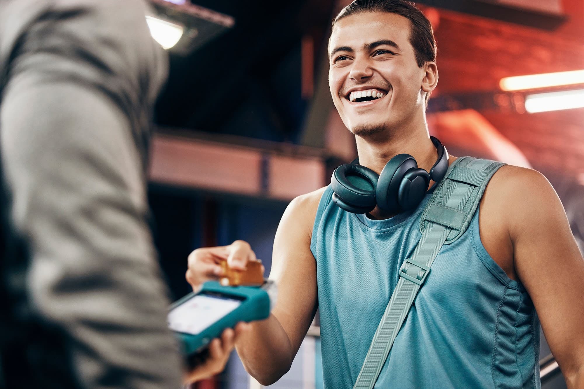 Gym manager using club management software on tablet in a modern gym