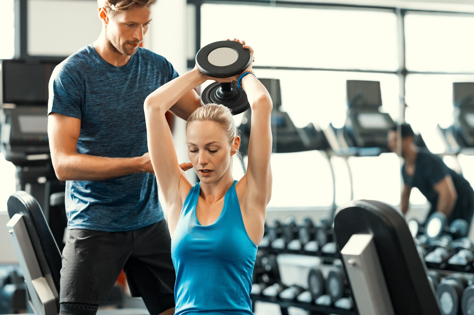 Gym staff using facility tracking software on screen
