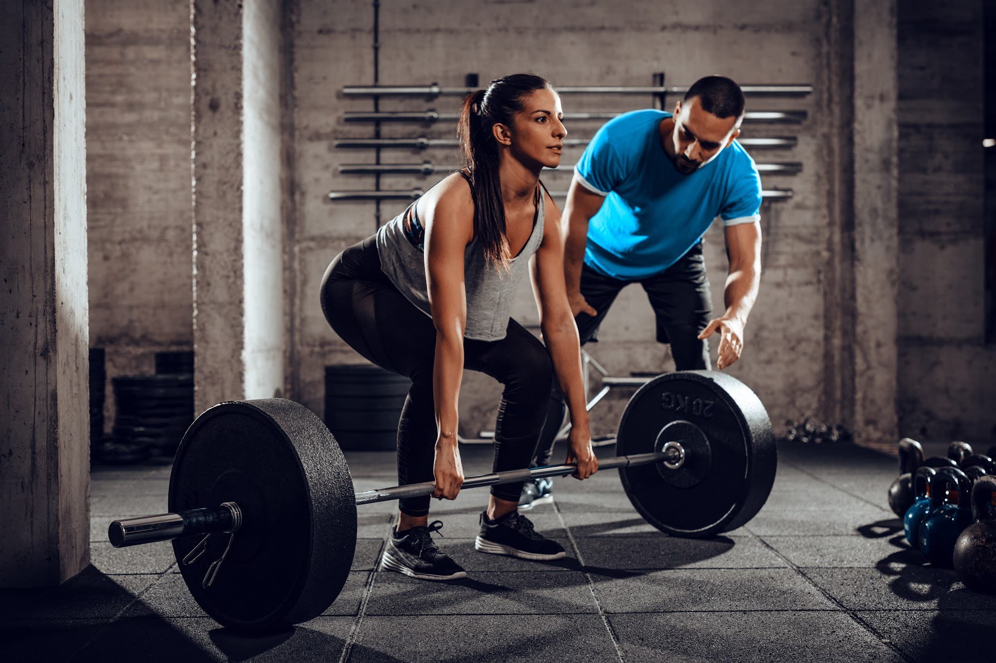 Tablet displays health club management software in a busy gym