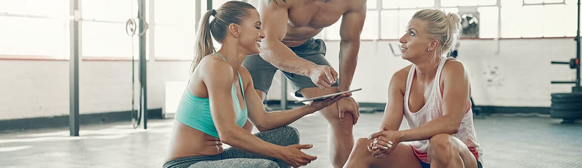 People discussing a strategy to level up their fitness club
