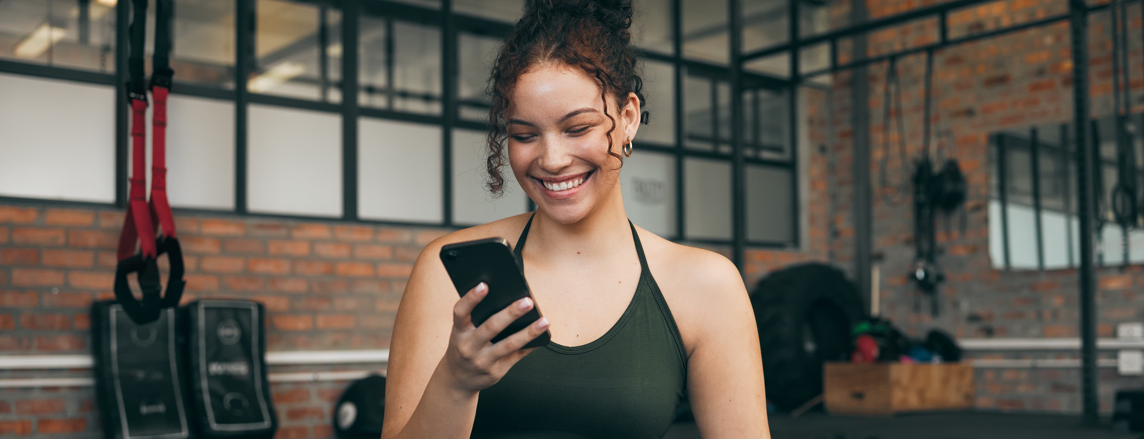 a person on their smartphone in between workouts