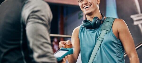 a member happily spending on fitness club membership