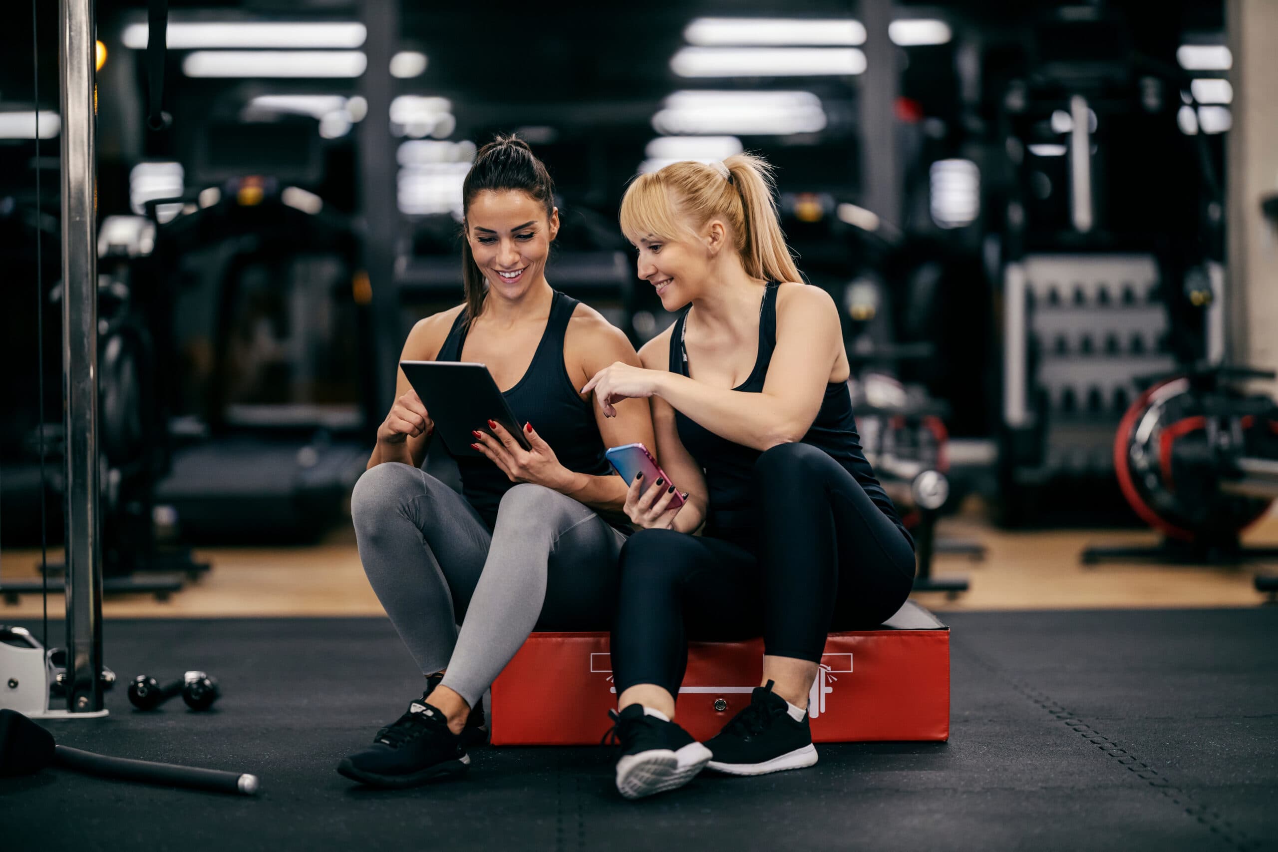 two people checking out the tablet at the fitness club