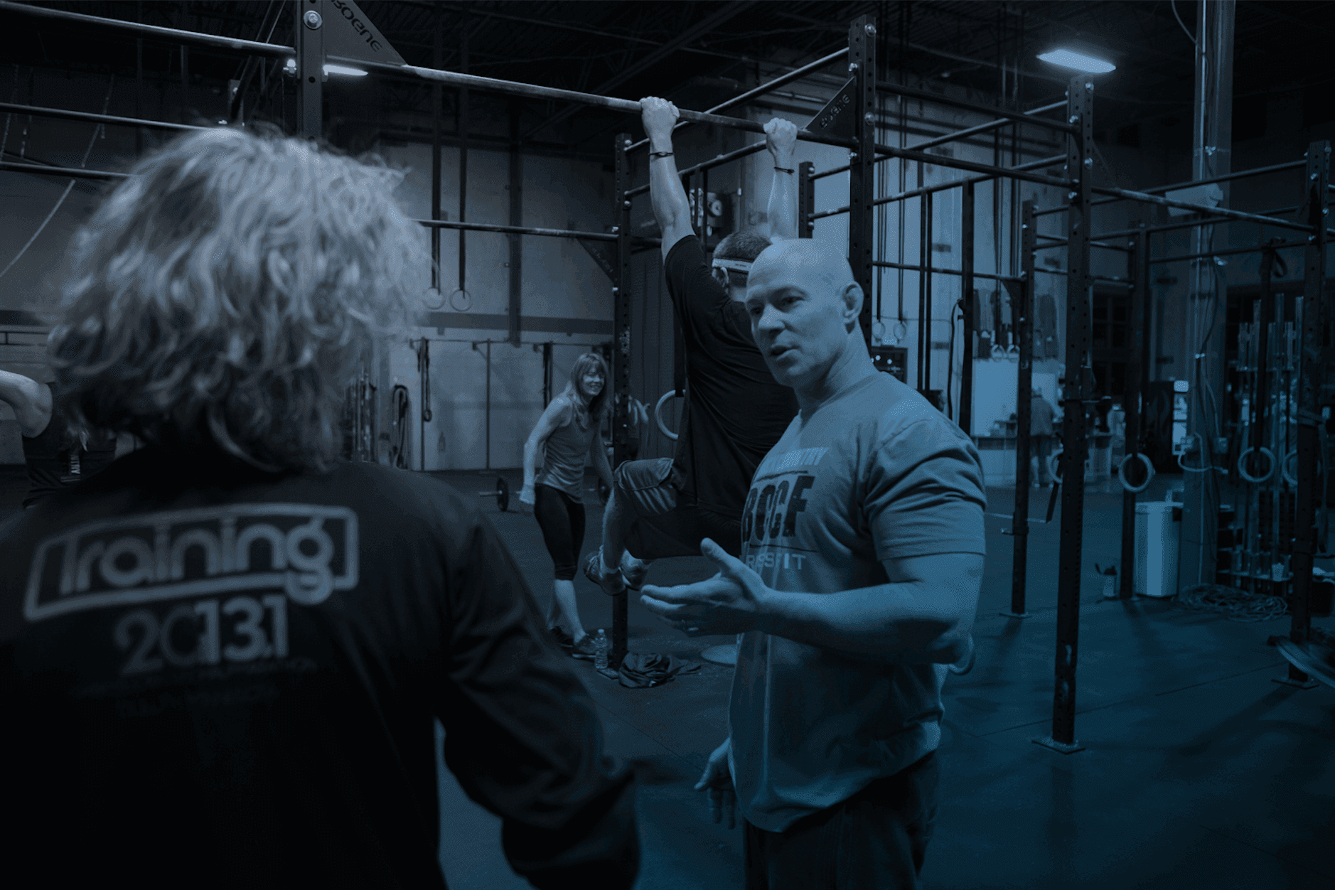 Fitness club manager reviewing AI recommendations on a tablet with a member