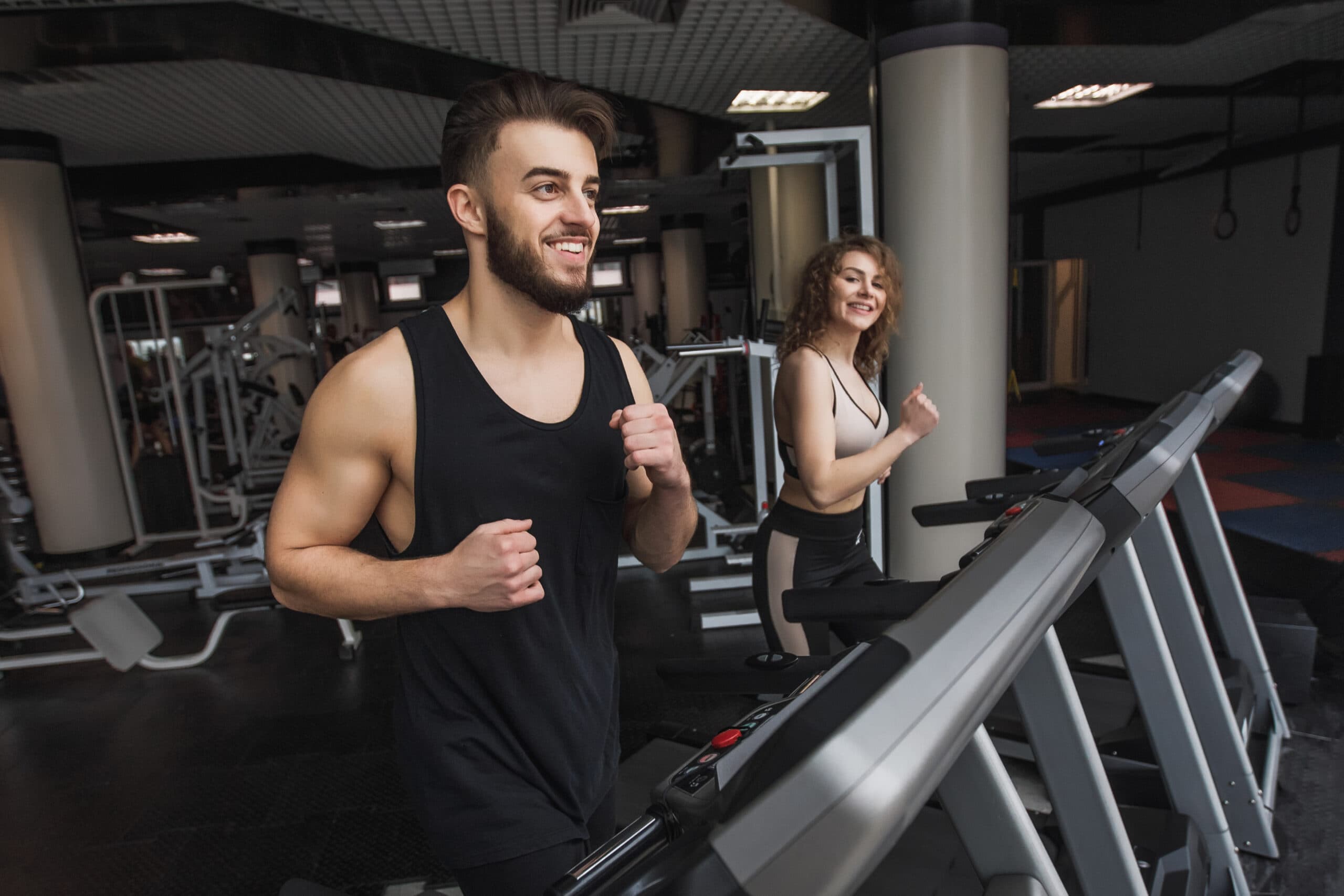 Young sports couple making cardio workout in a health club