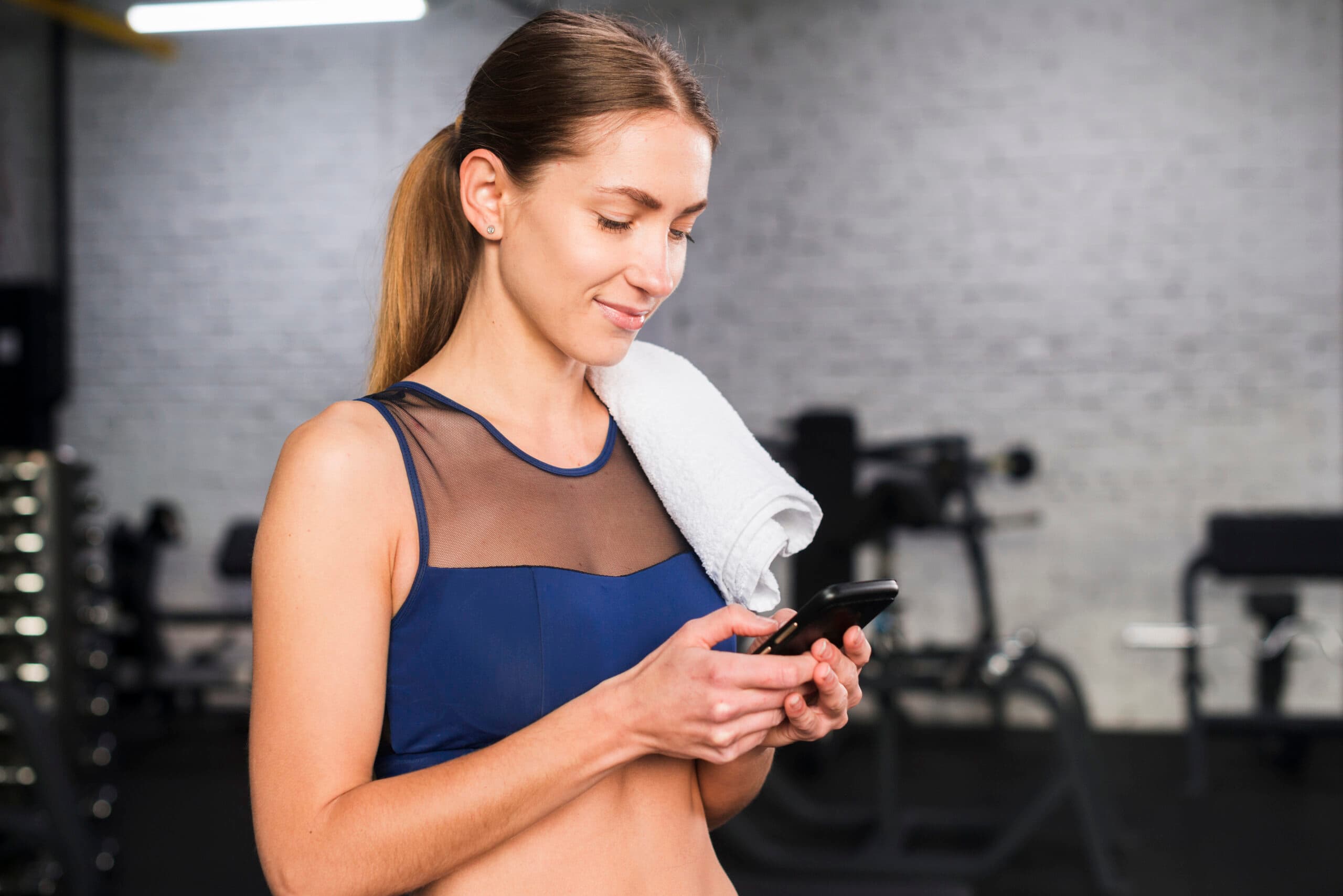 Women using mobile phone for gym training