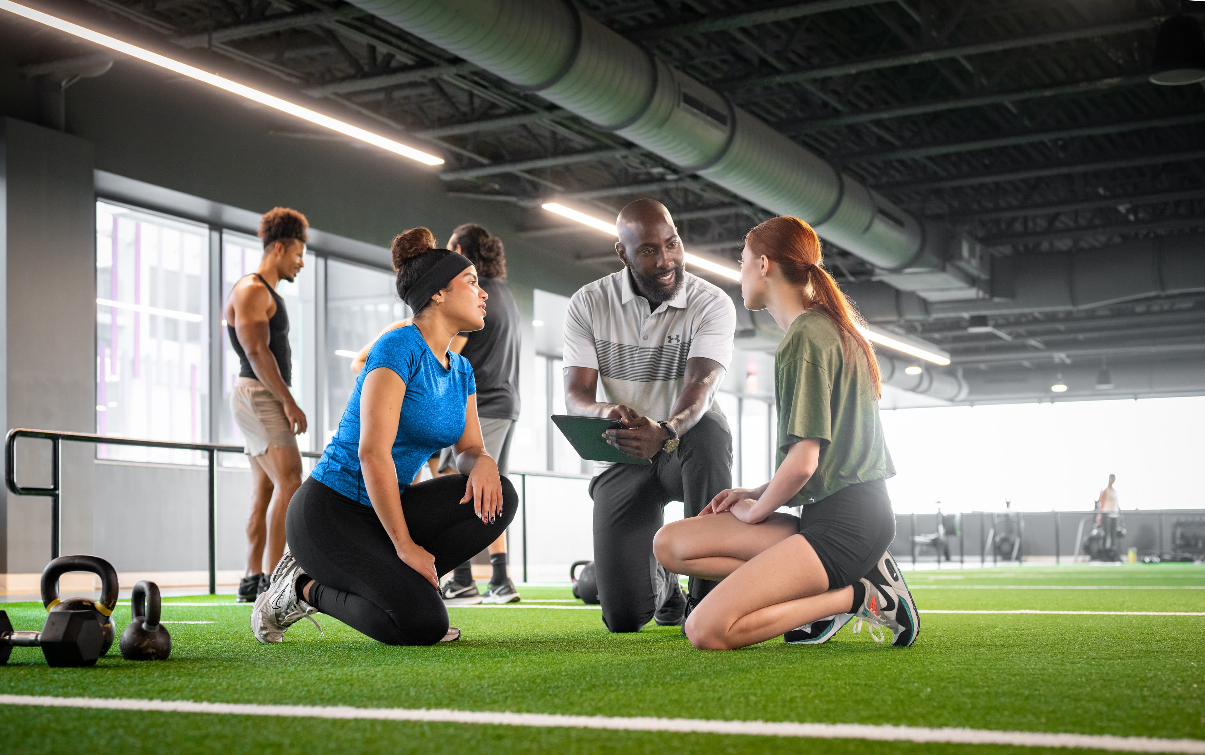 Fitness club manager reviewing analytics dashboard on laptop