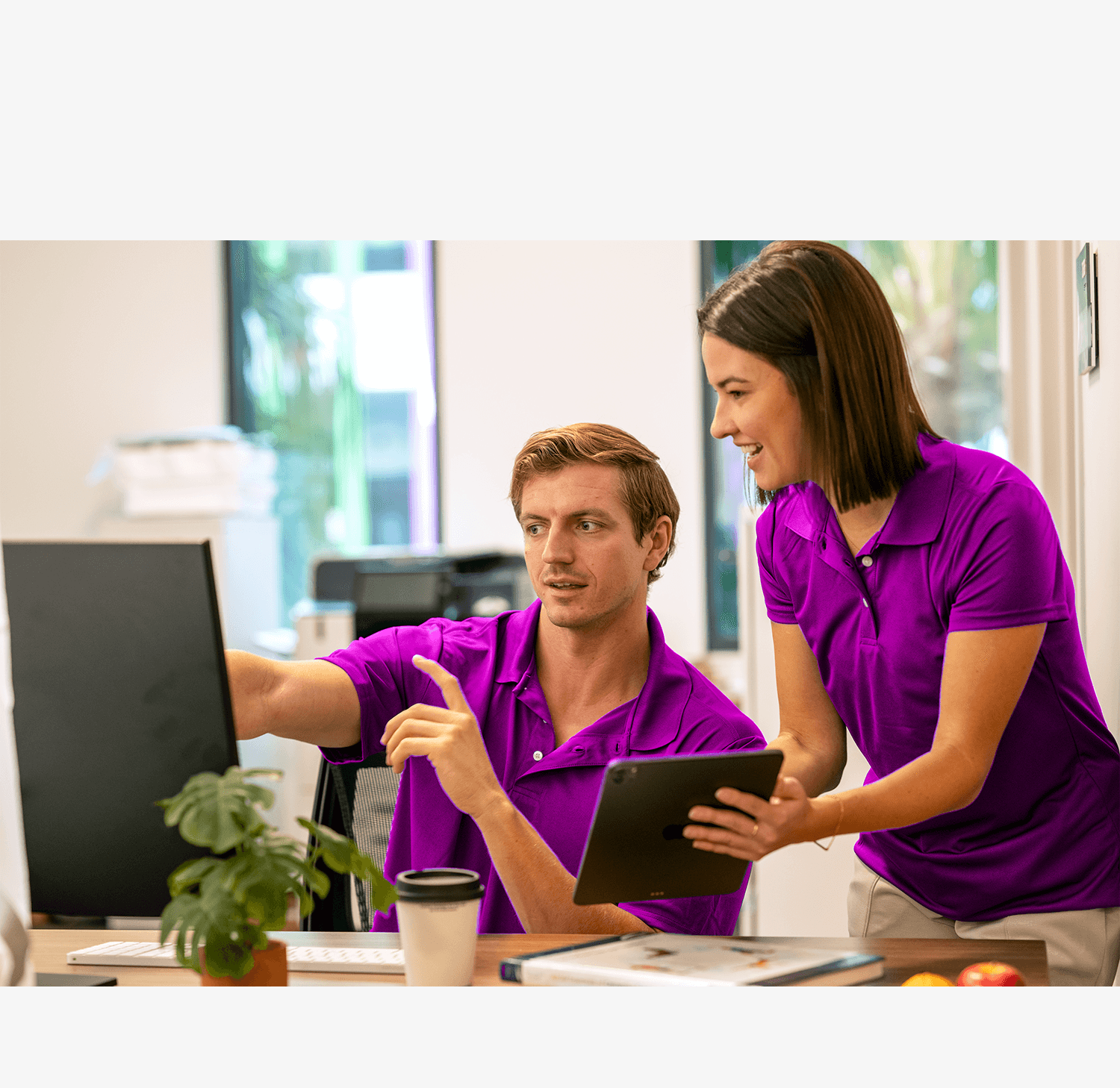 Fitness operator analyzing real-time performance data on Daxko Club Automation Dashboards in a gym office