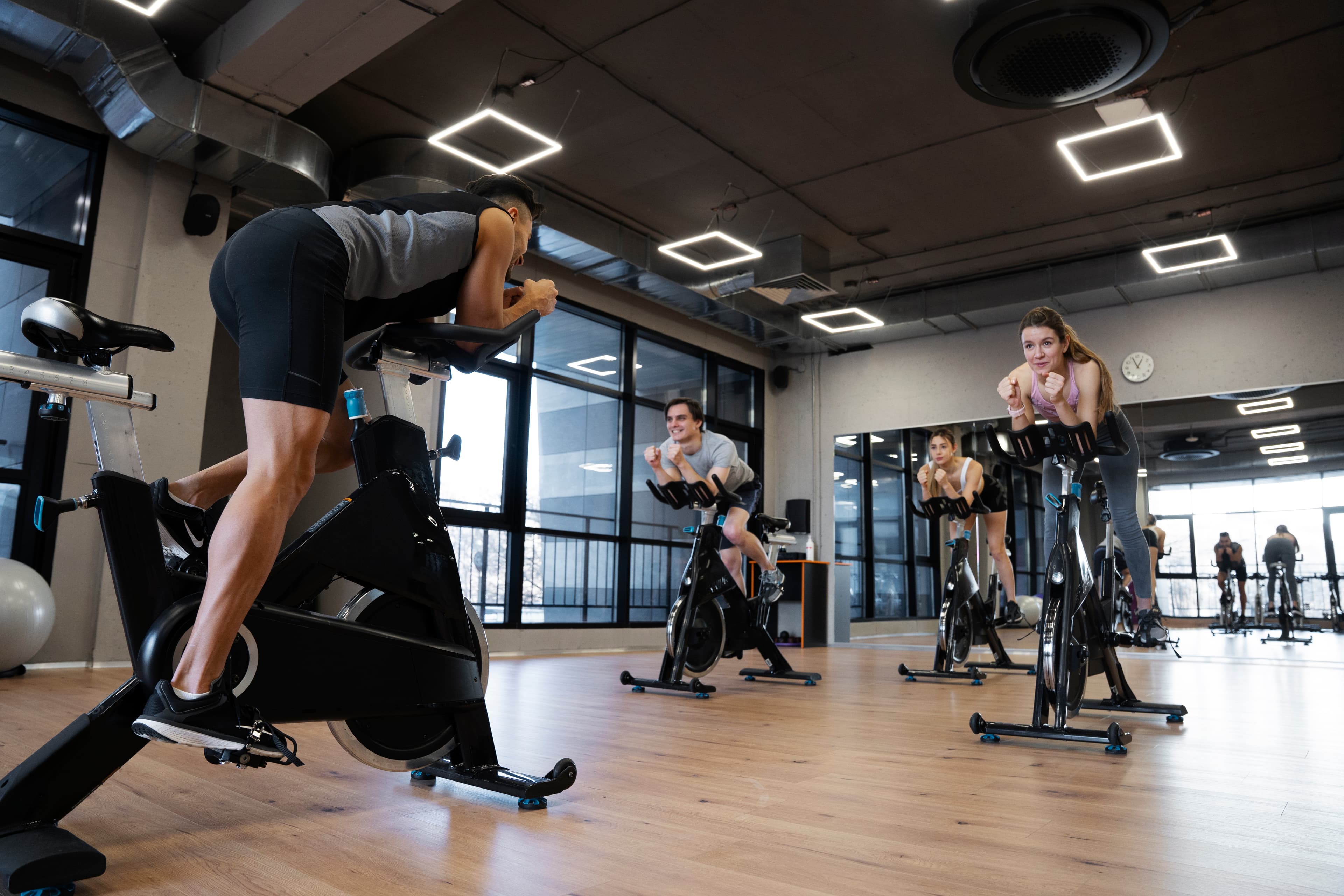 People doing indoor cycling at a fitness club
